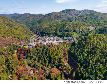 Aerial view of Takao, where the Arashiyama Takao Parkway runs. Below you can see Jingoji Temple and the mountain villages dyed in autumn colors. Ukyo Ward, Kyoto City, Kyoto 127974345