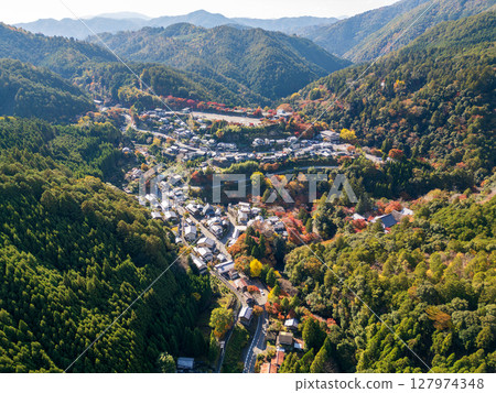 Aerial view of Takao, where the Arashiyama Takao Parkway runs. Below you can see Jingoji Temple and the mountain villages dyed in autumn colors. Ukyo Ward, Kyoto City, Kyoto 127974348