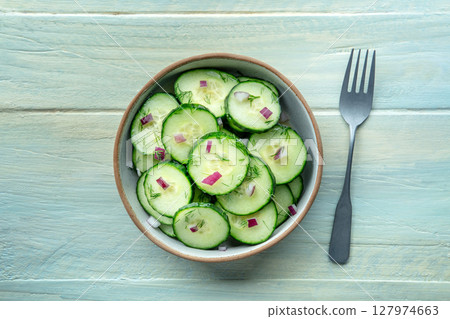 Cucumber salad with olive oil, dill and red onion, shot from above 127974663