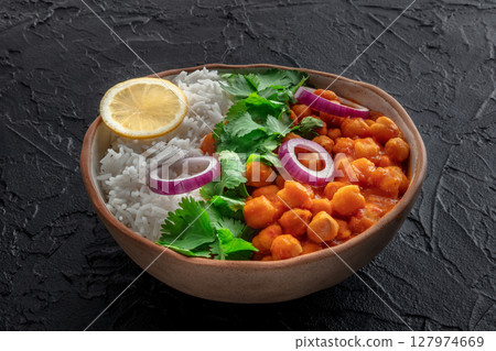 Chana masala, chickpea curry, traditional Indian dish, on black 127974669