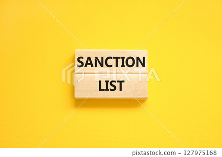 Sanction list symbol. Wooden blocks with concept words Sanction list on beautiful yellow background. Business political sanction list concept. Copy space. 127975168