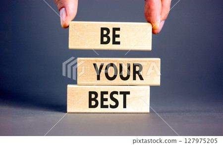 Motivational be your best symbol. Concept words Be your best on beautiful wooden blocks. Beautiful grey background. Businessman hand. Business motivational be your best concept. Copy space. 127975205