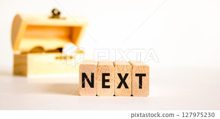 Next symbol. Concept word Next on beautiful wooden blocks. Beautiful wooden chest with coins. Beautiful white table white background. Business, lifestyle, support and next concept. Copy space. 127975230