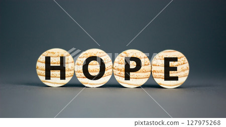 Hope symbol. Concept word Hope on beautiful wooden circles. Beautiful grey table grey background. Business, lifestyle, support and hope concept. Copy space. Hope symbol. Concept word Hope on beautiful wooden circles. Beautiful grey table grey background. Business, lifestyle, support and hope concept. Copy space. 127975268