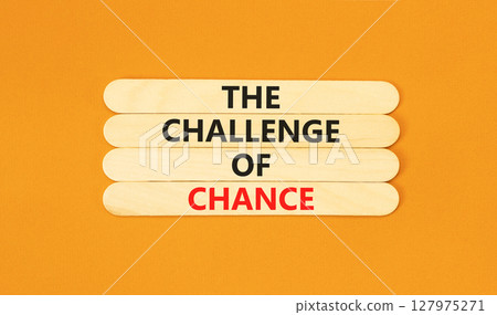 The challenge of chance symbol. Concept words phrase The challenge of chance on beautiful wooden stick. Beautiful orange paper background. Business The challenge of chance concept. Copy space. 127975271