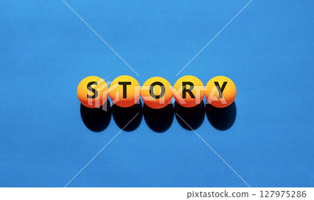 Story symbol. Concept word Story on beautiful yellow tennis ping pong balls. Beautiful wooden table wooden background. Business lifestyle story concept. Copy space. Story symbol. Concept word Story on beautiful yellow tennis ping pong balls. Beautiful wooden table wooden background. Business lifestyle story concept. Copy space. 127975286