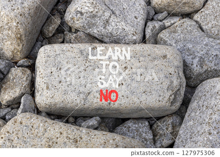 Learn to say no symbol. Concept words phrase Learn to say no on beautiful grey stone. Beautiful grey stone beach background. Business psychological Learn to say no concept. Copy space. 127975306