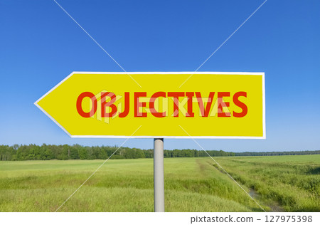 Objectives symbol. Concept word Objectives on beautiful yellow road sign. Beautiful blue sky green grass and forest peaceful nature background. Business objectives concept. Copy space. Objectives symbol. Concept word Objectives on beautiful yellow road sign. Beautiful blue sky green grass and forest peaceful nature background. Business objectives concept. Copy space. 127975398