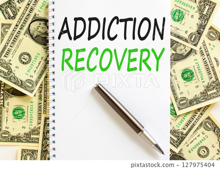 Addiction recovery symbol. Concept words Addiction recovery on beautiful white note. Beautiful background from dollar bills. Black pen. Psychology addiction recovery concept. Copy space. 127975404