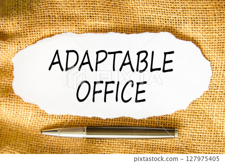 Adaptable office symbol. Concept words Adaptable office on beautiful white paper. Beautiful canvas background. Black pen. Business Adaptable office concept. Copy space. 127975405