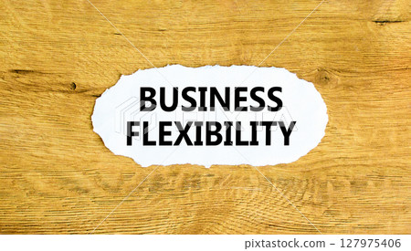 Business flexibility symbol. Concept words Business flexibility on beautiful white paper. Beautiful wooden wall background. Business flexibility concept. Copy space. Business flexibility symbol. Concept words Business flexibility on beautiful white paper. Beautiful wooden wall background. Business flexibility concept. Copy space. 127975406