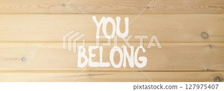 Belonging and you belong symbol. Concept words You belong on beautiful wooden wall. Beautiful wooden wall background. Business belonging and you belong concept. Copy space. 127975407