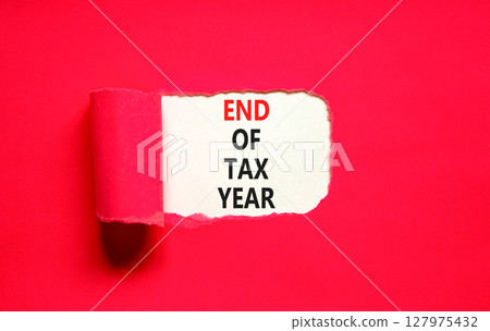 End of tax year symbol. Concept words phrase End of tax year on beautiful white paper. Beautiful red paper background. Business End of tax year concept. Copy space. End of tax year symbol. Concept words phrase End of tax year on beautiful white paper. Beautiful red paper background. Business End of tax year concept. Copy space. 127975432