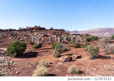Morocco semi-deserts and mountains, north africa nature, Moroccan stone desert, red hills, villages and argan trees 127975515