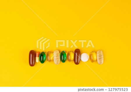 Color Pill Capsules on Yellow Background, Analgesic Pile, Transparent Painkiller Drugs Mix, Sedative Pills Color Pill Capsules on Yellow Background, Analgesic Pile, Transparent Painkiller Drugs Mix, Sedative Pills 127975523