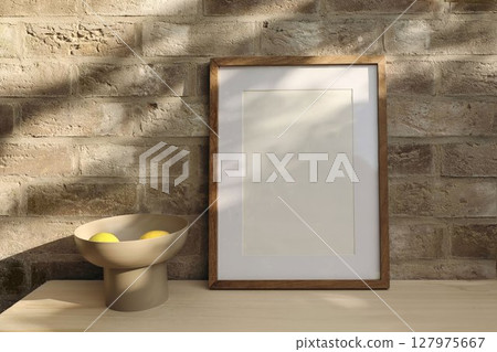 Elegant empty vertical wooden frame picture mockup, old brick textured wall in sunlight. Fresh yellow lemons fruit, modern bowl. Summer background with light, shadows. Mediterranean design. Elegant empty vertical wooden frame picture mockup, old brick textured wall in sunlight. Fresh yellow lemons fruit, modern bowl. Summer background with light, shadows. Mediterranean design. 127975667