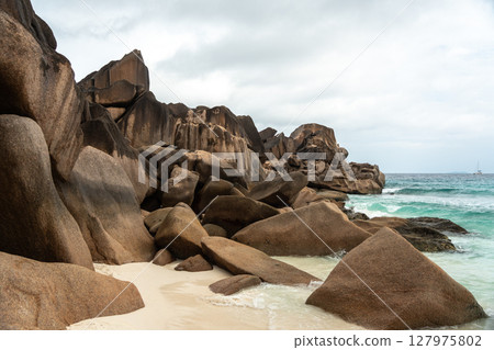 Granite boulders on La Digue form dramatic shapes along the tropical shoreline 127975802