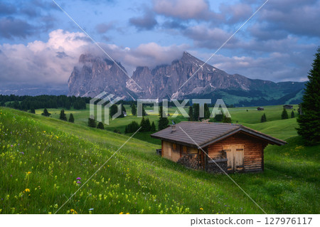 Idyllic mountain landscape with wooden house in mountain valley Idyllic mountain landscape with wooden house in mountain valley 127976117