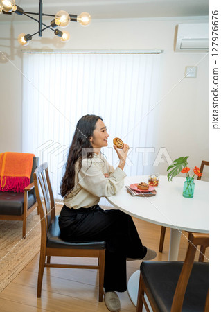A woman eating breakfast A woman eating breakfast 127976676