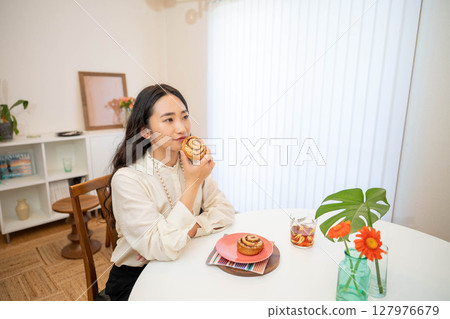 A woman eating breakfast A woman eating breakfast 127976679