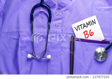 Vitamin B6 symbol. Concept words Vitamin B6 on beautiful white card. Stethoscope and pen. Beautiful medical uniform. Medical healthy lifestyle Vitamin B6 concept. 127977293