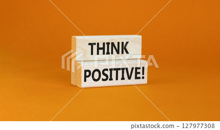 Think positive symbol. Concept words Think positive on beautiful wooden block. Beautiful orange table orange background. Business, motivational think positive thinking concept. Copy space. 127977308
