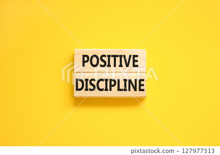 Positive discipline symbol. Concept words Positive discipline on beautiful wooden blocks. Beautiful yellow table yellow background. Business psychology positive discipline concept. Copy space. 127977313