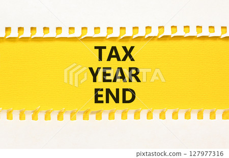 Tax year end symbol. Concept words Tax year end on beautiful yellow paper. Beautiful yellow white background. Business tax year end concept. Copy space. 127977316