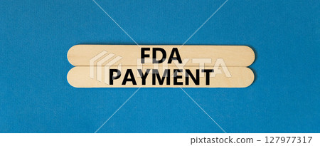 FDA Food and Drug Administration payment symbol. Concept words FDA payment on beautiful wooden stick. Beautiful blue table blue background. Business FDA payment concept. Copy space. FDA Food and Drug Administration payment symbol. Concept words FDA payment on beautiful wooden stick. Beautiful blue table blue background. Business FDA payment concept. Copy space. 127977317