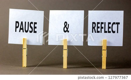 Pause and reflect symbol. Concept words Pause and reflect on beautiful white paper on clothespin. Beautiful grey background. Business motivational lifestyle pause and reflect concept. Copy space. 127977367
