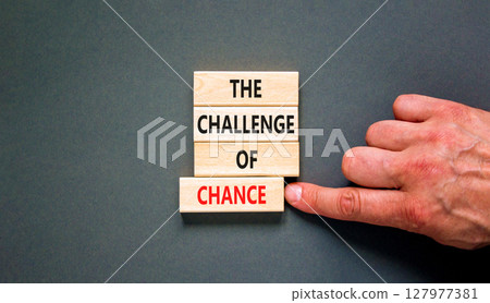 The challenge of chance symbol. Concept words phrase The challenge of chance on beautiful wooden blocks. Beautiful grey paper background. Business The challenge of chance concept. Copy space. 127977381