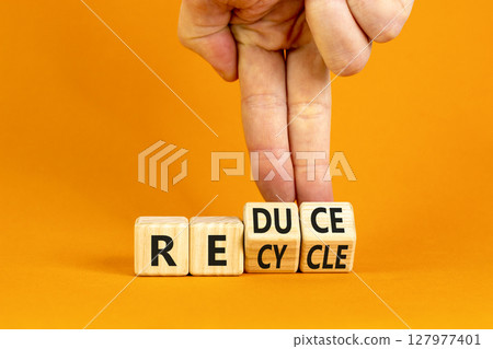 Reduce or recycle symbol. Concept words Reduce Recycle on wooden block. Beautiful orange table orange background. Businessman hand. Business reduce or recycle concept. Copy space. Reduce or recycle symbol. Concept words Reduce Recycle on wooden block. Beautiful orange table orange background. Businessman hand. Business reduce or recycle concept. Copy space. 127977401