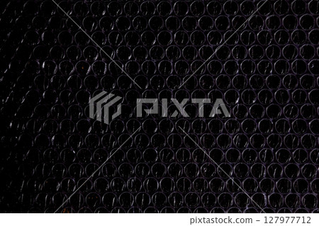 Dark bubble wrap macro texture Dark bubble wrap macro texture 127977712
