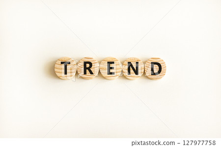 Trend and trending symbol. Concept word Trend on beautiful wooden circles. Beautiful white table white background. Business lifestyle trend and trending concept. Copy space. Trend and trending symbol. Concept word Trend on beautiful wooden circles. Beautiful white table white background. Business lifestyle trend and trending concept. Copy space. 127977758