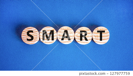 Smart symbol. Concept word Smart on beautiful wooden circles. Beautiful blue table blue background. Business lifestyle smart concept. Copy space. Smart symbol. Concept word Smart on beautiful wooden circles. Beautiful blue table blue background. Business lifestyle smart concept. Copy space. 127977759