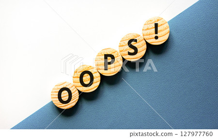 Oops symbol. Concept word Oops on beautiful wooden circles. Beautiful blue and white background. Business lifestyle oops concept. Copy space. Oops symbol. Concept word Oops on beautiful wooden circles. Beautiful blue and white background. Business lifestyle oops concept. Copy space. 127977760