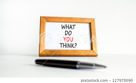 What do you think symbol. Concept words What do you think on beautiful wooden picture frame. Black pen. Beautiful white table white background. Business and What do you think concept. Copy space. 127978090