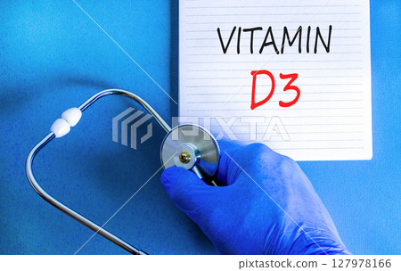 Vitamin D3 symbol. Concept words Vitamin D3 on beautiful white note. Doctor's hand in blue medical glove. Stethoscope. Beautiful blue background. Medical healthy lifestyle Vitamin D3 concept. 127978166