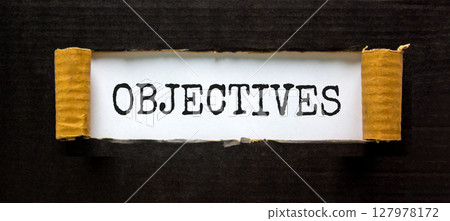 Objectives symbol. Concept word Objectives on beautiful white paper. Beautiful black paper background. Business objectives concept. Copy space. Objectives symbol. Concept word Objectives on beautiful white paper. Beautiful black paper background. Business objectives concept. Copy space. 127978172