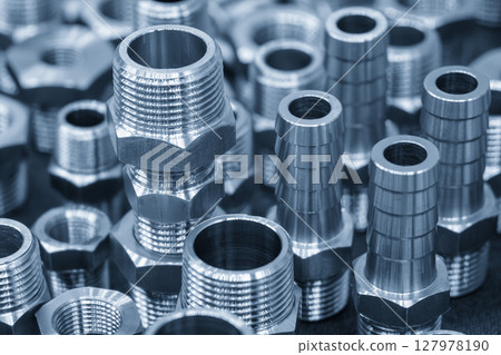 Close up scene the group of hexagon stainless steel pipe connector in the light blue scene. Close up scene the group of hexagon stainless steel pipe connector in the light blue scene. 127978190