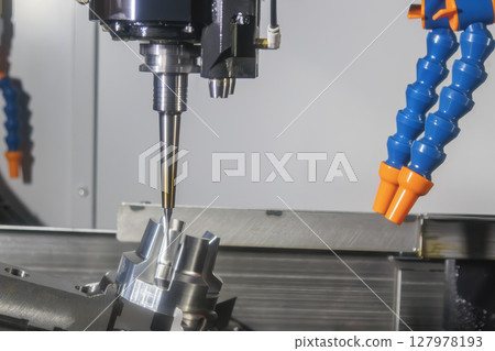 The 5-axis CNC milling machine finish cut the automotive part with solid ball nose end mill tool. 127978193