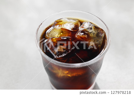 Cool iced coffee poured into a glass Cool iced coffee poured into a glass 127978218