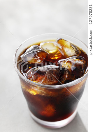 Cool iced coffee poured into a glass Cool iced coffee poured into a glass 127978221