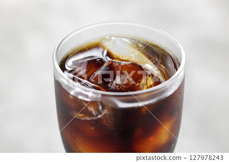 Cool iced coffee poured into a glass 127978243