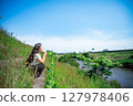 Young woman relaxing under the blue sky 127978406
