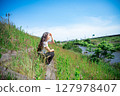 Young woman relaxing under the blue sky 127978407
