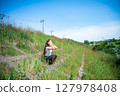 Young woman relaxing under the blue sky 127978408