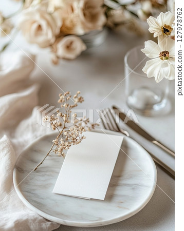 Minimalist greeting card on beige plate with white blossoms, top view 127978762