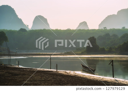 boat on Nong Thale swamp with limestone mountains at sunrise, Krabi 127979129