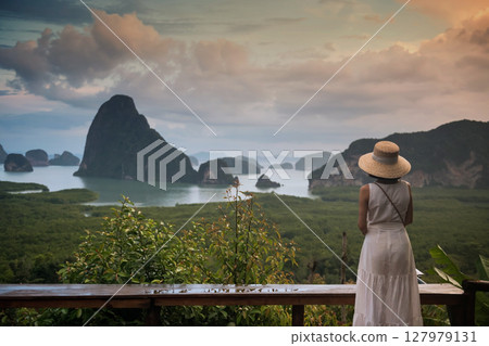 Asian woman view Phang Nga Bay from Samed Nang Chee viewpoint 127979131